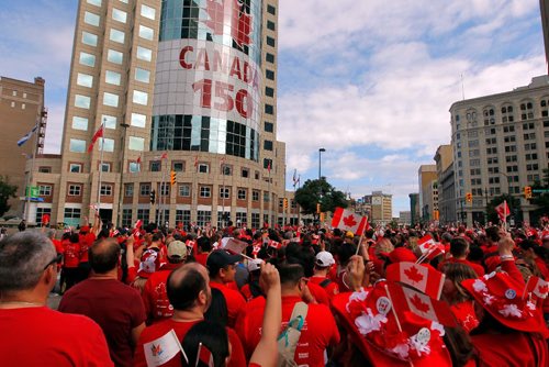 BORIS MINKEVICH / WINNIPEG FREE PRESS
3,600 proud Winnipeggers joined together bright and early at Portage & Main to create a human flag celebrating Canada Day. General photo of people at the event. July 1, 2017
