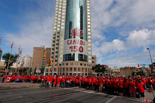 BORIS MINKEVICH / WINNIPEG FREE PRESS
3,600 proud Winnipeggers joined together bright and early at Portage & Main to create a human flag celebrating Canada Day. General photo of people at the event. July 1, 2017
