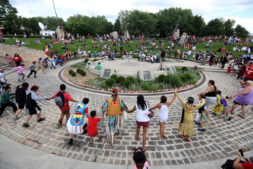 TREVOR HAGAN / WINNIPEG FREE PRESS
A crowd dancing around drummers in the Oodena circle during Canada Day and Canada 150 celebrations at the skate park at The Forks, Saturday, July 1, 2017.