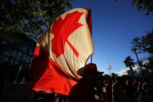 TREVOR HAGAN / WINNIPEG FREE PRESS
Man wearing a cowboy hat with a Canadian Flag during Canada Day and Canada 150 celebrations at The Forks, Saturday, July 1, 2017.