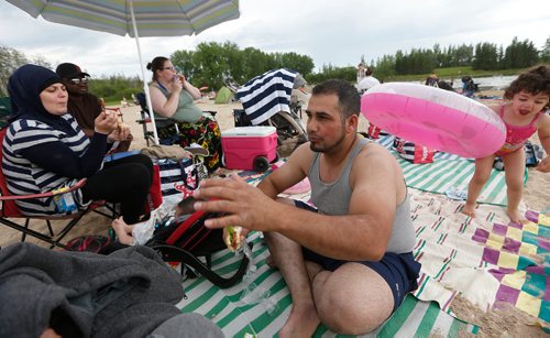 JOHN WOODS / WINNIPEG FREE PRESS
While sitting with his family and friends at Bird's Hill Park beach Monday, July 3, 2017 Jihad Zahra, originally from Lebanon, tells a story of his near drowning during his first swimming experience in Canada .

