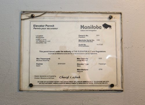 JUSTIN SAMANSKI-LANGILLE / WINNIPEG FREE PRESS
A Manitoba elevator permit is seen inside the elevator of 762 Wolseley Tuesday. The permit, like most in the city, has been signed by Cheryl Lashek, who now has an Instagram fan page dedicated to her.
170704 - Tuesday, July 04, 2017.