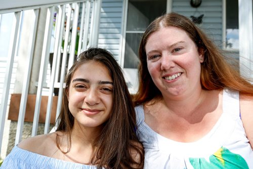 JUSTIN SAMANSKI-LANGILLE / WINNIPEG FREE PRESS
14 year-old Paige Oritz (L) and her mother, Nicole Abbott pose on their front steps Tuesday. Oritz has used the Sunshine Fund 5 times and says she enjoys camp because she gets to meet new people and learn about God.
170704 - Tuesday, July 04, 2017.