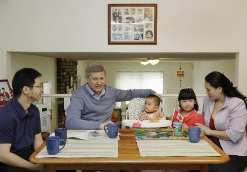 Prime Minister Stephen Harper speaks with Fei Chen, her husband Edwin Huang and their daughter Renee Huang and son Eric Huang during a campaign stop in Richmond, BC, September 9, 2008. Canandians go to the polls in a Federal election October 14. Lyle Stafford For the Winnipeg Free Press