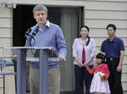 Prime Minister Stephen Harper speaks to the media as Fei Chen, her husband Edwin Huang and their daughter Renee Huang look on during a campaign stop in Richmond, BC, September 9, 2008. Canandians go to the polls in a Federal election October 14. Lyle Stafford For the Winnipeg Free Press