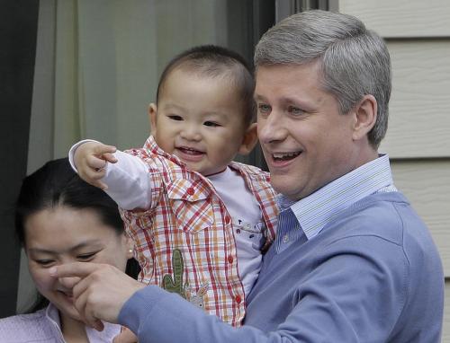 Prime Minister Stephen Harper holds 14 month old Eric Huang while his mother Fei Chen looks on during a campaign stop in Richmond, BC, September 9, 2008. Canandians go to the polls in a Federal election October 14. Lyle Stafford For the Winnipeg Free Press