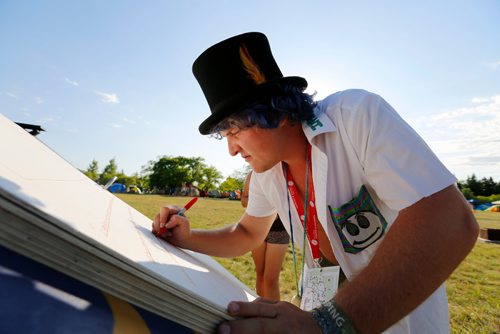 JUSTIN SAMANSKI-LANGILLE / WINNIPEG FREE PRESS
A festival goer calling himself "Smiley" writes a fabel in a giant book in the Folk Festival campgrounds Wednesday.
170705 - Wednesday, July 05, 2017.
