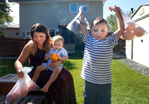 WAYNE GLOWACKI / WINNIPEG FREE PRESS

 'Zero Waste' lifestyle.    Sarah Carroll with her sons Thomas,5, and Jack,2, on her lap in the backyard with their reusable grocery produce bags. The family throws out as little garbage as possible.  Dave Baxter story  July 6  2017