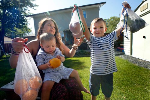 WAYNE GLOWACKI / WINNIPEG FREE PRESS

 'Zero Waste' lifestyle.   Sarah Carroll with her sons Thomas,5, and Jack,2, on her lap in the backyard with their reusable shopping produce bags. The family throws out as little garbage as possible.  Dave Baxter story  July 6  2017