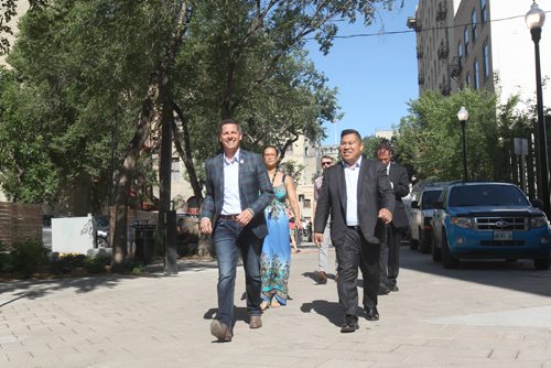 JOE BRYKSA / WINNIPEG FREE PRESSMayor Brian Bowman, left, and Point Douglas city councilor Ray Pagtakhan walk down newly renovated John Hirsch Place Thursday to show off the improvements made to the Northeast Exchange district- The city and province worked together since 2012 to complete  $14 Million of improvements including underground road infrastructure, enhancing pedestrian realm with wider sidewalks, planting 130 trees, new lighting, and a innovative drainage design pilot on John Hirsch Place  .    -  July 06 , 2017 -( See Ryan Thorpe story)
