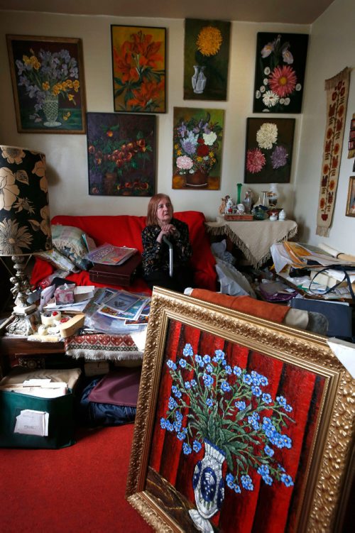 WAYNE GLOWACKI / WINNIPEG FREE PRESS

Undiscovered artist and would-be published author  Grazyna (Grace) Brown surrounded by her art work in her home in the North End. In the foreground is a oil painting of Forget-me-not flowers. Gord Sinclair  story  July 6  2017