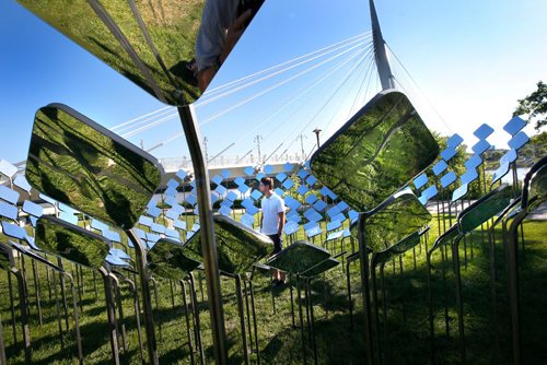 WAYNE GLOWACKI / WINNIPEG FREE PRESS

Tim Smith with the Marc Boutin Architectural Collaborative based in Calgary, AB. checks out their invited submission titled Bend at Esplanade Riel (The Forks). This is one of the three new Cool Gardens 2017 and four returning gardens officially unveiled Friday morning. Through the clustering of mirrors, enjoy the reflection of both the sky and earth, which creates a third and alternative visual space. Cool Gardens presented by StorefrontMB, The Forks and La Maison des artistes is a public exhibition that celebrates contemporary garden culture, public art and the local landscape. This year, it will include six installation sites running from Main Street through the Forks to Provencher Boulevard in Winnipeg, as well as one at the Riverbank Discovery Centre in Brandon. release  July 7  2017
