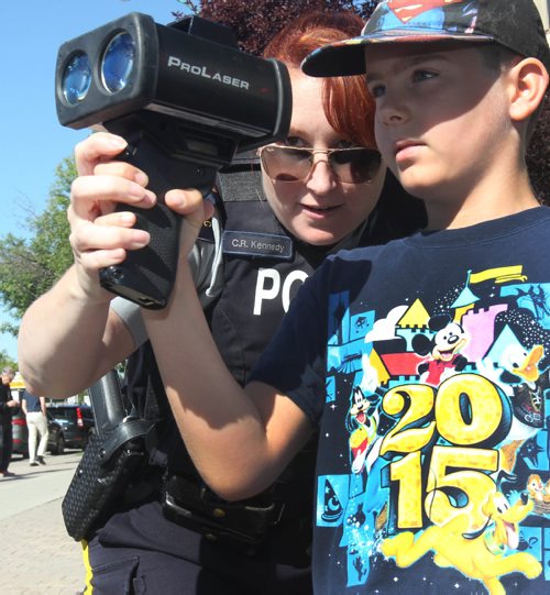 JOE BRYKSA / WINNIPEG FREE PRESS
As part of Canada 150 celebrations RCMP D Division Headquarters invited the public to come and view, meet their Manitoba RCMP and have a chance to view RCMP equipment and see demonstrations- Corporal Carrie Kennedy from Headingley Traffic Services shows Hremique Cloutier a laser speed gun  -  July 07 , 2017 -( Standup Photo)