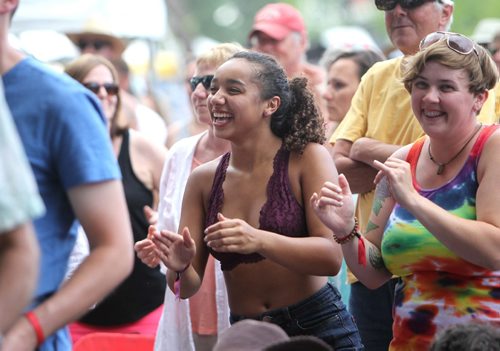 RUTH BONNEVILLE / WINNIPEG FREE PRESS

Kari Johnson (curly hair, centre) dances and claps with the band on stage with her friend Amanda Murphy (rainbow shirt) beside her at the 44th annual Folk Festival at Birds Hill Park Saturday.  

July 08, 2017