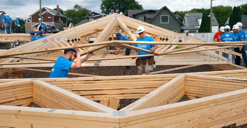 WAYNE GLOWACKI / WINNIPEG FREE PRESS

Volunteers Matt Rondeau,left, and Laurie Etkin lift a roof truss for a house being constructed Monday. About 500 volunteers started building  20 homes on Lyle St. Monday morning as part of the Habitat for Humanitys 34th Jimmy & Rosalynn Carter Work Project¤ that runs July 9-14 in cities across Canada. Together they will be building 150 homes in celebration of Canadas 150th anniversary.Kevin Rollason story  July 10  2017