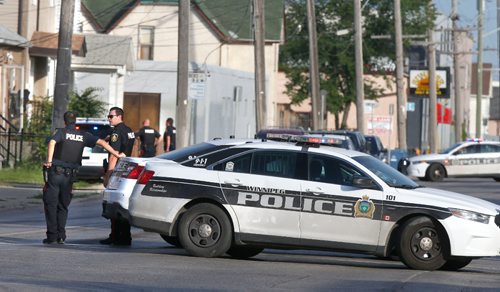 WAYNE GLOWACKI / WINNIPEG FREE PRESS

Winnipeg Police closed Logan Ave. at Sherbrook St Monday morning.  A reported armed standoff after a break-in at a residence housing a grow-op resulted a stretch of Logan Avenue being closed early Monday morning. July 10  2017