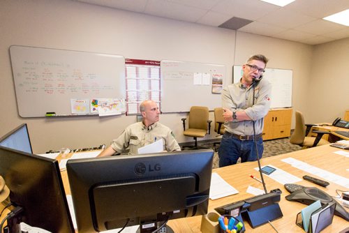 JUSTIN SAMANSKI-LANGILLE / WINNIPEG FREE PRESS
Stephen Tulle (L) and Dave Bokovay (R) man the operations centre Monday. The Canadian Interagency Forest Fire Centre manages and organizes resources from across the country here in their operations centre.
170710 - Monday, July 10, 2017.