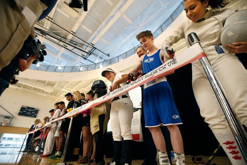 WAYNE GLOWACKI / WINNIPEG FREE PRESS

Manitoba athletes Chase Reid-McLean (shorts) and at left Mary Martin (ball cap) beside Premier Brian Pallister help do the honours at the Official Grand Opening Ribbon Cutting Ceremony for the Canada Games Sport for Life Centre Tuesday held in the Qualico Training Centre Gymnasium. Intern  story  July 11  2017