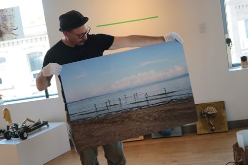 Canstar Community News July 4, 2017 - Douglas Lewis shows one of the paintings that will be featured in his show Jus Toyin Around. (LIGIA BRAIDOTTI/CANSTAR COMMUNITY NEWS/TIMES)