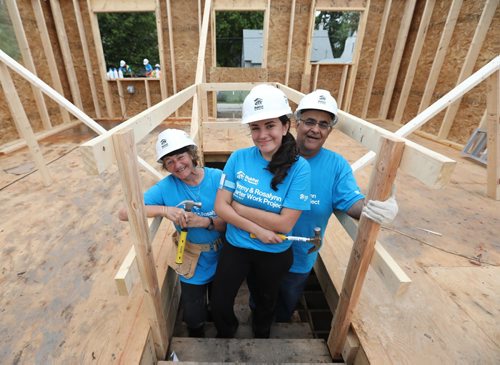 RUTH BONNEVILLE / WINNIPEG FREE PRESS

Photo of Kiran Kumar (front) with her mom Renee and dad Teddy  on basement stairs of a home they are helping to build  on Carter build site.  

The Kumar family, Teddy, his wife Renee and daughter Kiran from  Princeton New Jersey spend a week of their holidays volunteering their time to build homes for Habitat for Humanity at The Carter build site in St. James Tuesday.    Their daughter Kiran asked to volunteer for habitat  as her graduation gift .  Former U.S. president Jimmy Carter and his wife Rosalynn will help build homes on Thursday.  
July 11, 2017