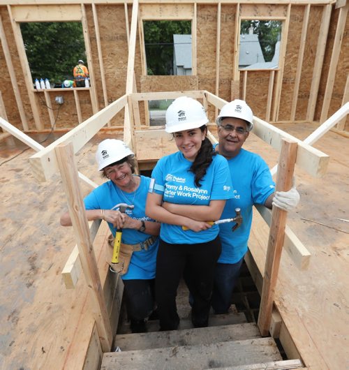 RUTH BONNEVILLE / WINNIPEG FREE PRESS

Photo of Kiran Kumar (front) with her mom Renee and dad Teddy  on basement stairs of a home they are helping to build  on Carter build site.  

The Kumar family, Teddy, his wife Renee and daughter Kiran from  Princeton New Jersey spend a week of their holidays volunteering their time to build homes for Habitat for Humanity at The Carter build site in St. James Tuesday.    Their daughter Kiran asked to volunteer for habitat  as her graduation gift .  Former U.S. president Jimmy Carter and his wife Rosalynn will help build homes on Thursday.  
July 11, 2017