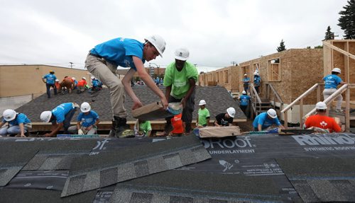 RUTH BONNEVILLE / WINNIPEG FREE PRESS



Volunteers and soon-to-be homeowners carry shingles onto roof of home while volunteering for  Habitat for Humanity at The Carter build site in St. James Tuesday.   Former U.S. president Jimmy Carter and his wife Rosalynn will help build homes on Thursday.  
Generic photo from build site.  
 
July 11, 2017