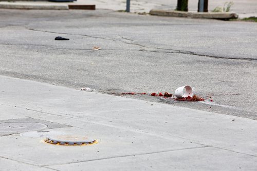 JUSTIN SAMANSKI-LANGILLE / WINNIPEG FREE PRESS
A smashed fruit smoothie is seen near a red SUV and some bloody paper towels in a gas station parking lot at the corner of Maryland and Portage Tuesday evening.
170711 - Tuesday, July 11, 2017.