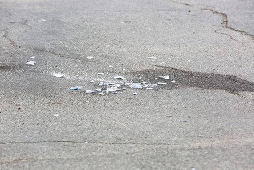 JUSTIN SAMANSKI-LANGILLE / WINNIPEG FREE PRESS
broken glass is seen near a red SUV and some bloody paper towels in a gas station parking lot at the corner of Maryland and Portage Tuesday evening.
170711 - Tuesday, July 11, 2017.