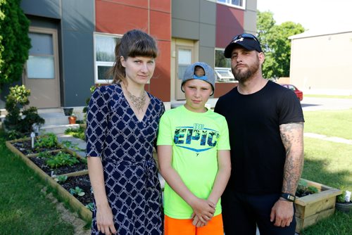 JUSTIN SAMANSKI-LANGILLE / WINNIPEG FREE PRESS
Joey Cowan poses with Jessica Schmidt and his son Jackson in front of his garden Wednesday. Manitoba Housing says that Cowan has to remove the raised garden he built in his front yard as it is a hazard for young children and gardens belong in the backyard yard only.
170712 - Wednesday, July 12, 2017.