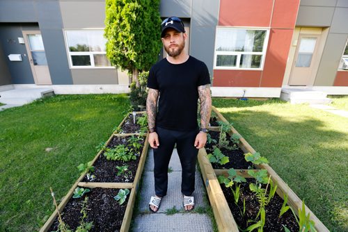 JUSTIN SAMANSKI-LANGILLE / WINNIPEG FREE PRESS
Joey Cowan poses in his garden Wednesday. Manitoba Housing says that Cowan has to remove the raised garden he built in his front yard as it is a hazard for young children and gardens belong in the backyard yard only.
170712 - Wednesday, July 12, 2017.
