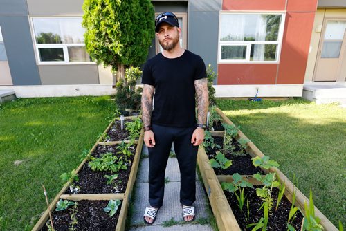 JUSTIN SAMANSKI-LANGILLE / WINNIPEG FREE PRESS
Joey Cowan poses in his garden Wednesday. Manitoba Housing says that Cowan has to remove the raised garden he built in his front yard as it is a hazard for young children and gardens belong in the backyard yard only.
170712 - Wednesday, July 12, 2017.