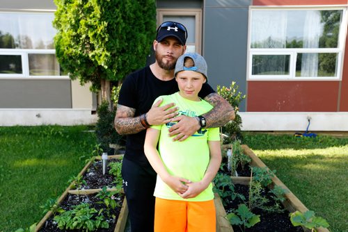 JUSTIN SAMANSKI-LANGILLE / WINNIPEG FREE PRESS
Joey Cowan poses in his garden with his son Jackson Wednesday. Manitoba Housing says that Cowan has to remove the raised garden he built in his front yard as it is a hazard for young children and gardens belong in the backyard yard only.
170712 - Wednesday, July 12, 2017.