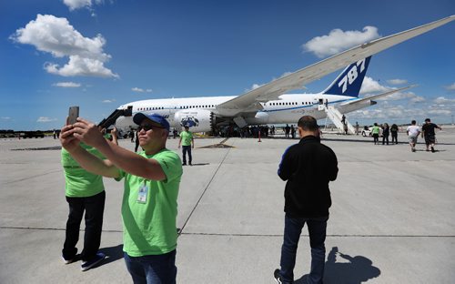 RUTH BONNEVILLE / WINNIPEG FREE PRESS

Boeing employee Remy Sabale takes a photo of himself with a Boeing 787 Dreamliner airplane behind that he and 500 Boeing employees from Winnipeg got to view and touch on tarmac at airport Thursday.  The employees were bused to the site to see a completed airline with components built by them in Winnipeg plant after it made a special landing in Winnipeg.  
See Biz story.  

July 13, 2017