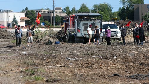 WAYNE GLOWACKI / WINNIPEG FREE PRESS

Ten protesters by a tree clearing vehicle in the Parker wetlands on Friday morning to halt clearcutting of the land, saying they are determined to stop the machines "at any cost." Ashley Prest/ intern story July 14   2017