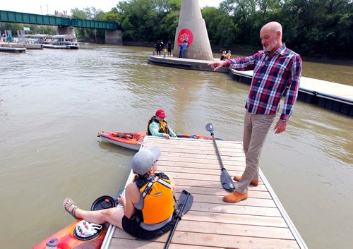 BORIS MINKEVICH / WINNIPEG FREE PRESS
CEO of The Forks Paul Jordan says boat traffic is rebounding after three dismal summers, and interestingly, notes canoe/kayak traffic is up dramatically, to the point The Forks is about to install specialized docks for these watercraft. Here he stands on the docks where the new docks will be installed soon. Two kayakers, Maria Lutz, bottom, and Shawn DeMerigan, top, chat with Jordan about this. KELLY TAYLOR STORY.  July 14, 2017