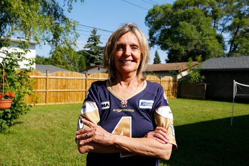 JUSTIN SAMANSKI-LANGILLE / WINNIPEG FREE PRESS
Karen Kuldys poses outside her home Friday. Kuldys was set to win $1 million during last night's Blue Bombers game when a controversial penalty call in the second quarter cost her the prize.
170714 - Friday, July 14, 2017.
