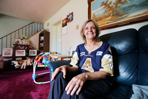 JUSTIN SAMANSKI-LANGILLE / WINNIPEG FREE PRESS
Karen Kuldys poses insider her home Friday. Kuldys was set to win $1 million during last night's Blue Bombers game when a controversial penalty call in the second quarter cost her the prize.
170714 - Friday, July 14, 2017.