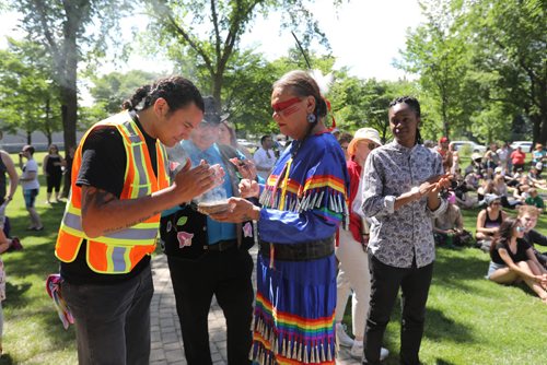 \RUTH BONNEVILLE / WINNIPEG FREE PRESS

Kelly Houle dressed in traditional jingle dress holds smudge for MLA Wab Kinew Fort Rouge. as people gather at K.R. Barkman park for the 2nd annual Steinbach Pride Parade Saturday.


July 15, 2017