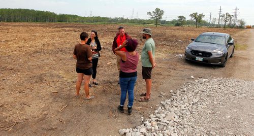 BORIS MINKEVICH / WINNIPEG FREE PRESS
Parker Lands development protestors are camped out on the development site to try to stop it. From left, protestor Jenna Vandal, police, police, Katelyn McIntyre, purple hair, and Dirk Hoeppner. BEN WALDMAN STORY  July 17, 2017