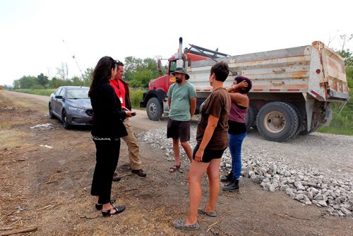 BORIS MINKEVICH / WINNIPEG FREE PRESS
Parker Lands development protestors are camped out on the development site to try to stop it. From left, police, police, Dirk Hoeppner, Jenna Vandal, and Katelyn McIntyre. BEN WALDMAN STORY  July 17, 2017