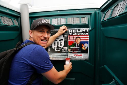 JUSTIN SAMANSKI-LANGILLE / WINNIPEG FREE PRESS
DK Reinemer tapes a poster advertising his Fringe Fest show, "" onto the door of a porta-potty Tuesday. Fringe Fest starts Wednesday and features performances by artists from around the world.
170718 - Tuesday, July 18, 2017.