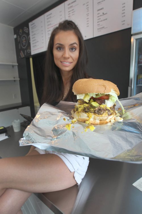 JOE BRYKSA / WINNIPEG FREE PRESS Vicky Ramantanis from Vickys Dinner shows off the Vickys Favorite burger -  July 19 , 2017 -( See  Sanderson story)