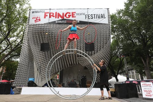 RUTH BONNEVILLE / WINNIPEG FREE PRESS

Street performer from Australia Hannah Cryle performs stunts with her wheel with the help of audience member Karen Dobrucki  on stage at the Cube in Old Market Square Wednesday afternoon as part of the kickoff to the annual Winnipeg Fringe Festival.  

Standup photo 

July 19, 2017