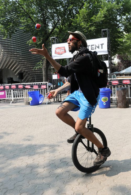 RUTH BONNEVILLE / WINNIPEG FREE PRESS

Daniel Both juggles while riding a unicycle for fun while at the 30th annual Fringe Festival in Market Square Thursday afternoon.  
Standup photo   
July 20, 2017
