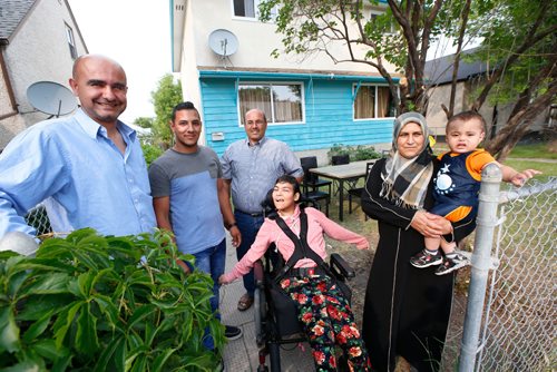 WAYNE GLOWACKI / WINNIPEG FREE PRESS

From left, Nour Ali and his employee Yahya Kazmouz with his father Ibrahim, his sister Rasha and his mother Maha Ahmad holding his cousin Ibrahim. Yahya Kazmouz a Syrian refugee who arrived in the big wave of refugees two winters ago. After his first year here, his refugee support ran out and he went on social assistance for a short time but is now working full time for Thank You Canada, a company that does restoration work, demolition, etc. Carol Sanders story   July 20   2017