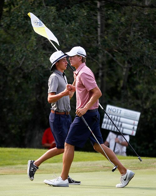 PHIL HOSSACK / WINNIPEG FREE PRESS  -  Manitoba Amature Champion Travis Fredborg and his caddy Sylvain Ruest trade knuckle bumps on the13th of the day (hole 4th green) Thursday as the Manitoba Men's Amature Golf tournament wrapped up. See Mike Sawatzsky's story.-  July 20, 2017