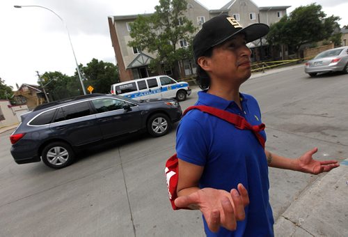 PHIL HOSSACK / WINNIPEG FREE PRESS  -  Only giving his name as Raymond, a neighborhood witness talks to Melissa Saturday as Police investigators work the scene of a shooting/homicide at 101-740 Selkirk Ave Saturday morning. See melissa Martin's story.   -  July 22, 2017