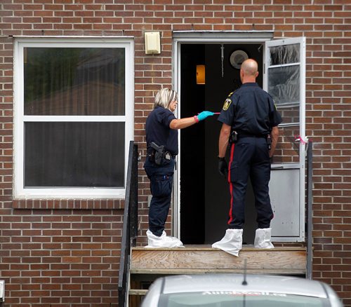 PHIL HOSSACK / WINNIPEG FREE PRESS  -  Police investigators work the scene of a shooting/homicide at 101-740 Selkirk Ave Saturday morning. See melissa Martin's story.   -  July 22, 2017