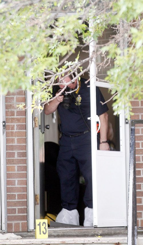 PHIL HOSSACK / WINNIPEG FREE PRESS  -  Police investigators work the scene of a shooting/homicide at 101-740 Selkirk Ave Saturday morning. See melissa Martin's story.   -  July 22, 2017