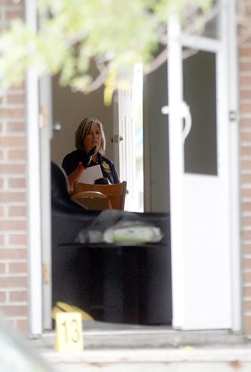 PHIL HOSSACK / WINNIPEG FREE PRESS  -  Police investigators work the scene of a shooting/homicide at 101-740 Selkirk Ave Saturday morning. See melissa Martin's story.   -  July 22, 2017